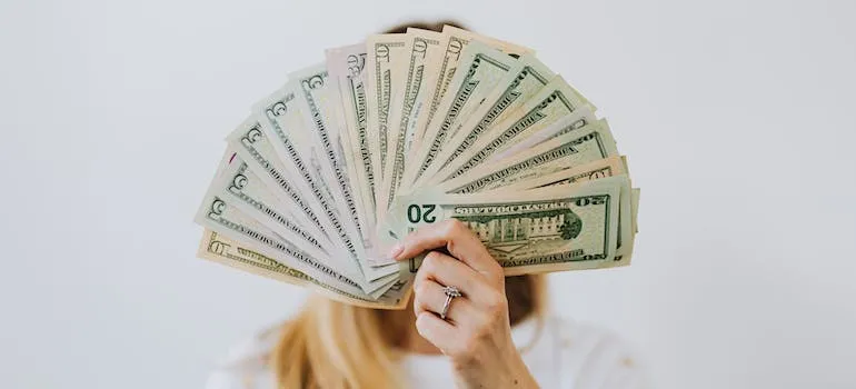 A woman holding dollar bills